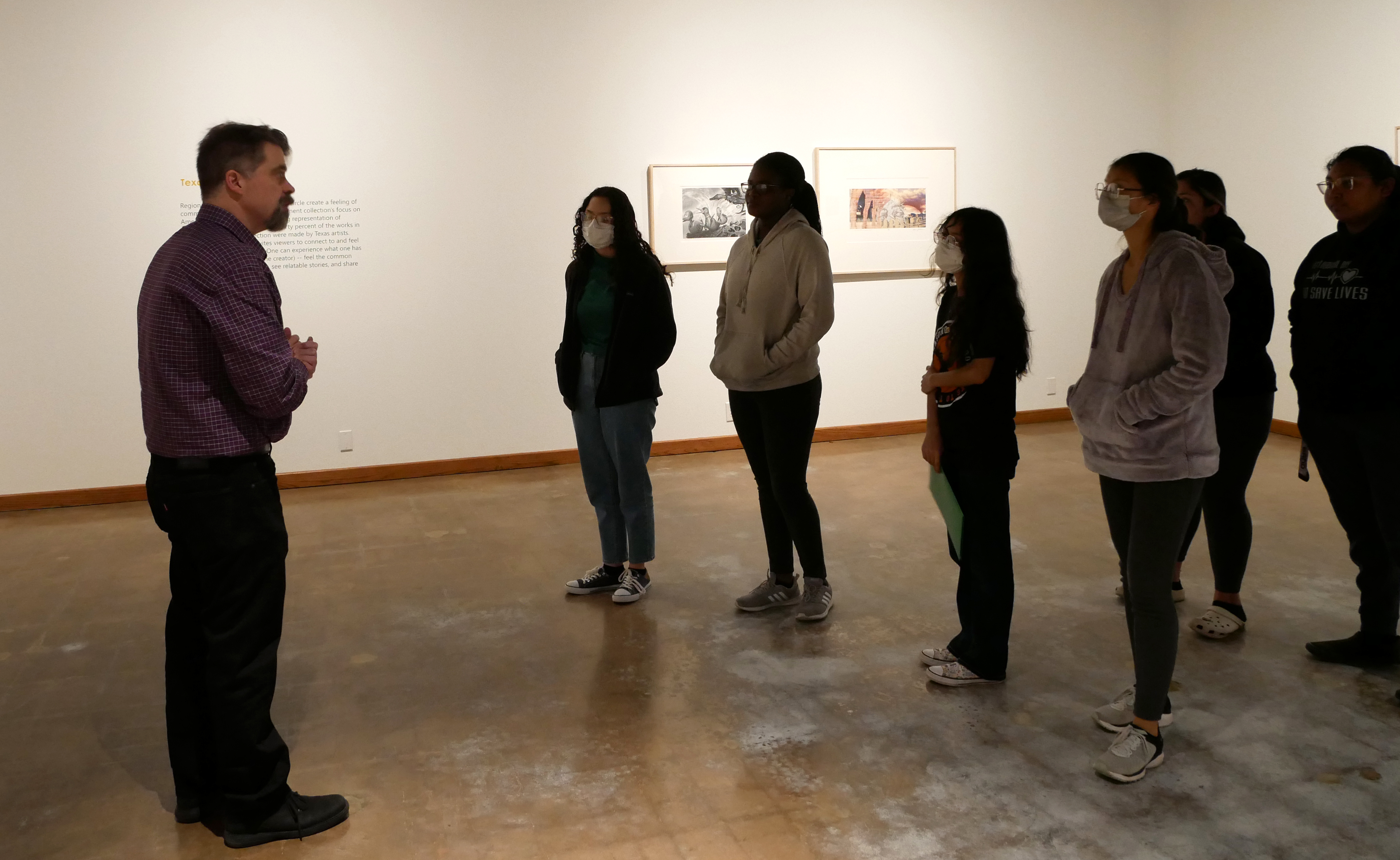 WFMA curator Danny Bills gives student's from Cafe Con Leche an exhibition tour.